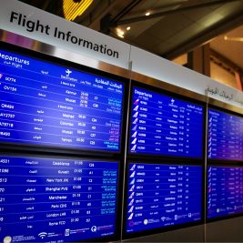 Departure boards at Hamid International Airport.