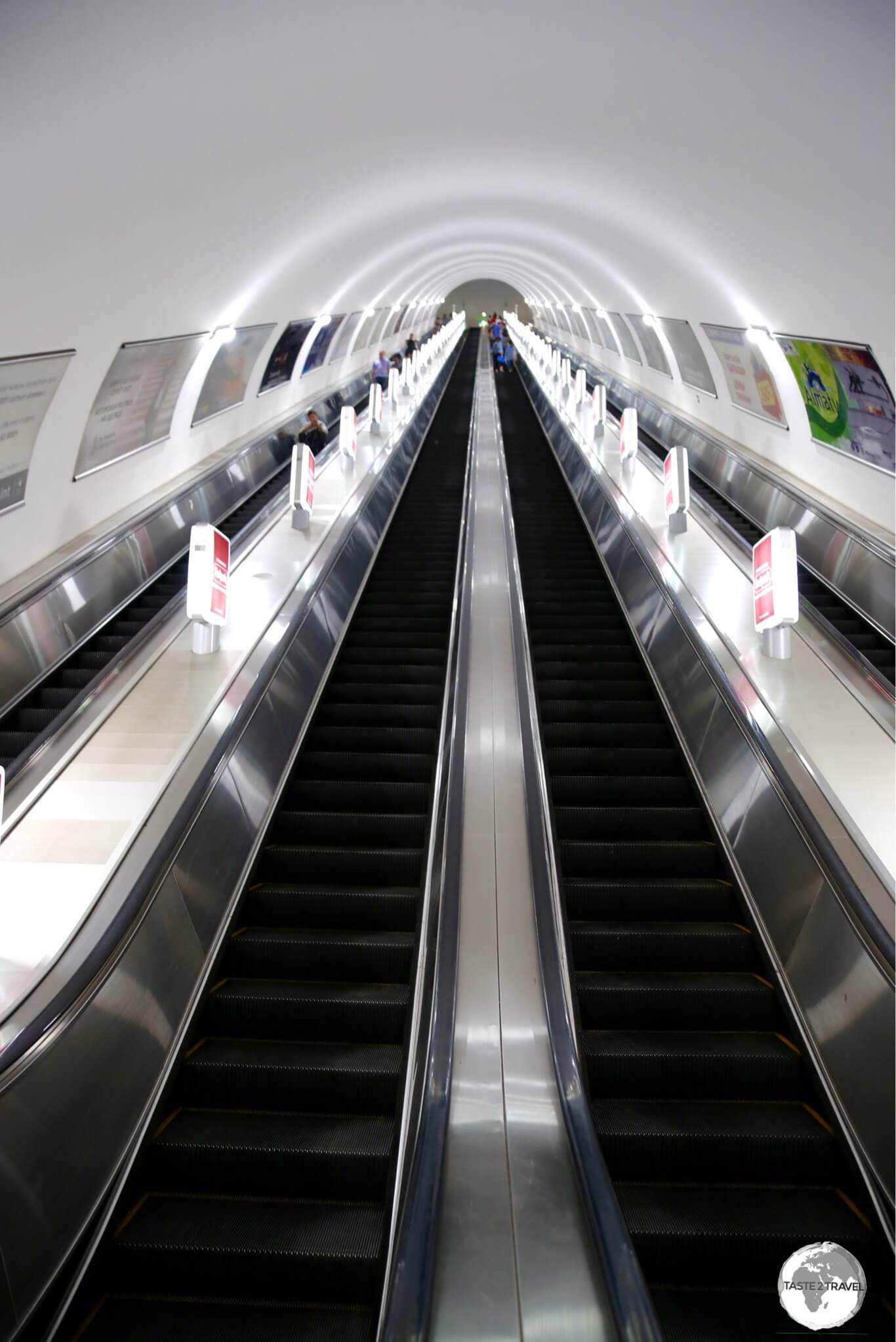 Locals often sit while riding the incredibly long escalators on the Almaty metro. 