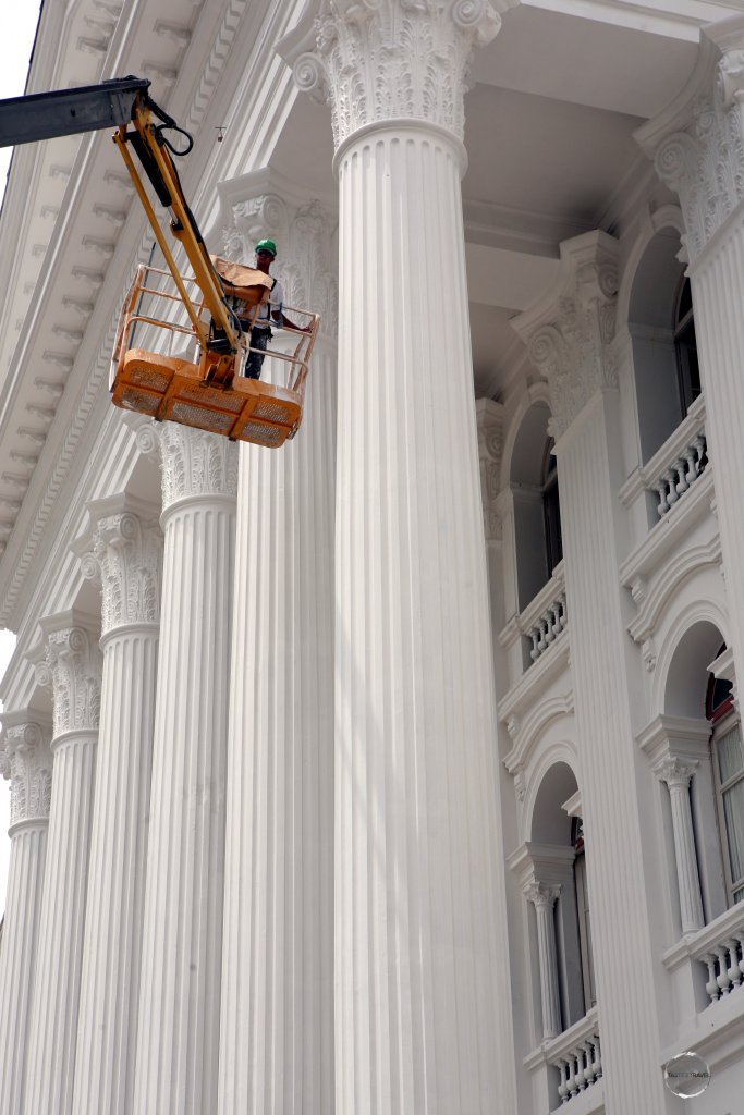 A workman, painting the façade of the Federal University of Paraná, which lies on Santos Andrade square in Curitiba.