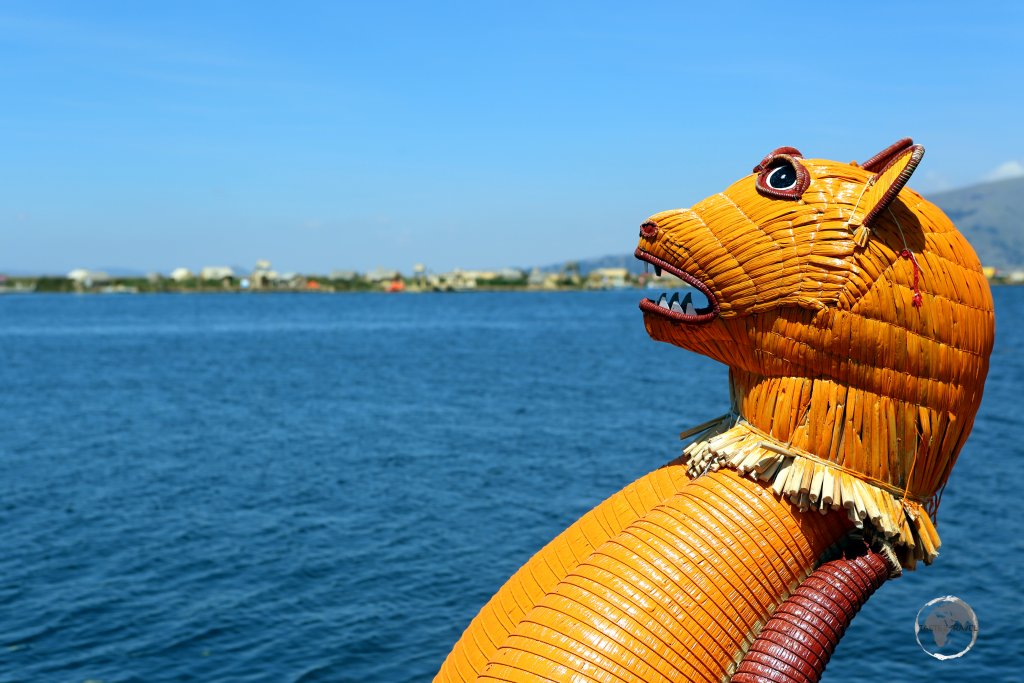 An orange puma rears up on Lake Titicaca! Detail from a Totora reed boat on the Uros Islands, which are located on Lake Titicaca, near Puno, Peru.