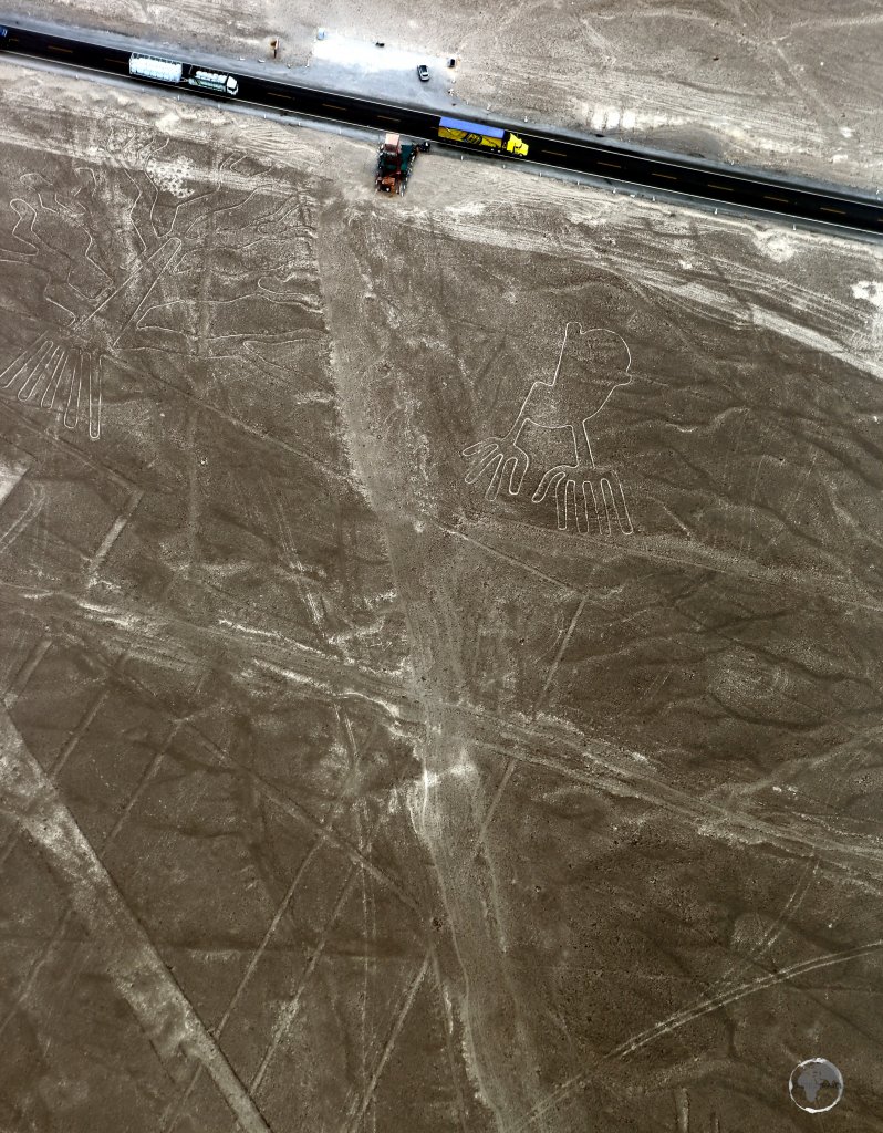 Passing trucks on the main coastal highway provide scale to two Nazca Lines figures; the 'Tree' (left) and the 65-metre long 'Hands' (right).