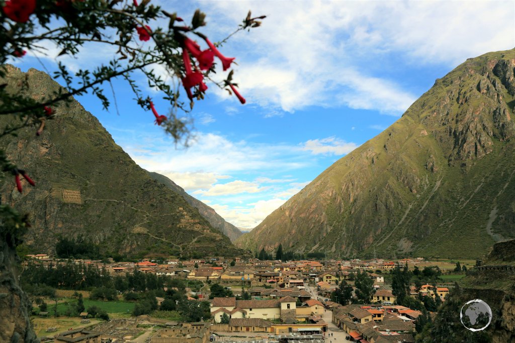 A view of the Peruvian Andean town of Ollantaytambo, from the Ollantaytambo ruins, a massive Inca fortress with large stone terraces on a hillside.