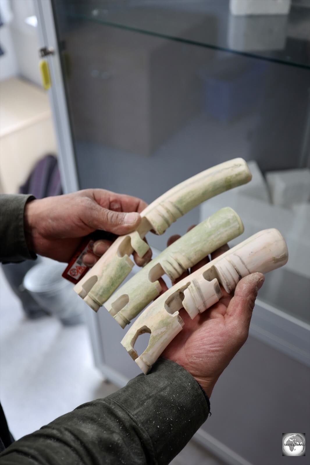 A bone-carver, displaying his carvings, at the Ajagaq workshop in Nuuk.