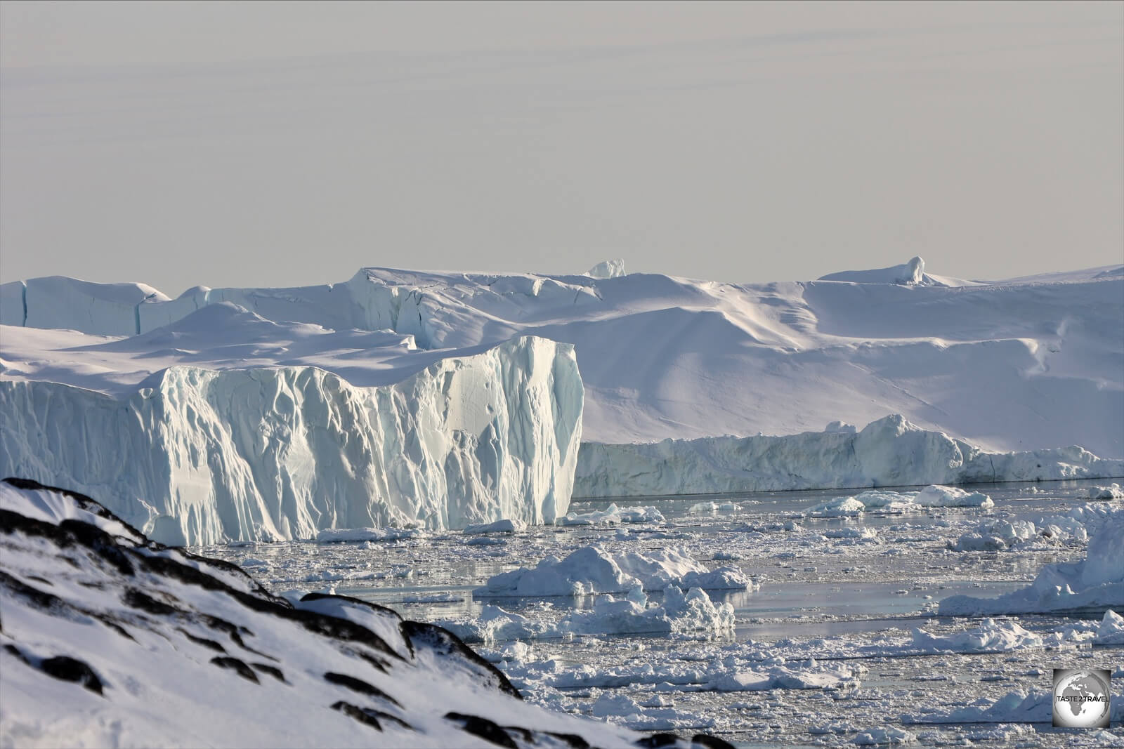 The midnight sun, reflecting off of icebergs in the Ilulissat Icefjord.