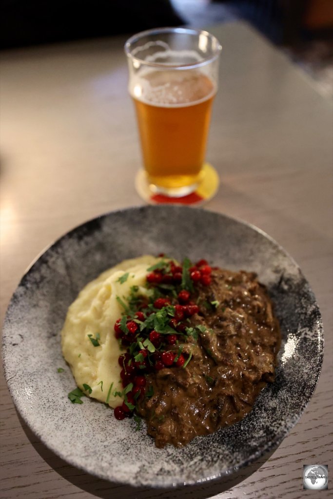 Reindeer stew with a glass of Svalbard brewery beer at Barentz pub in Longyearbyen. 