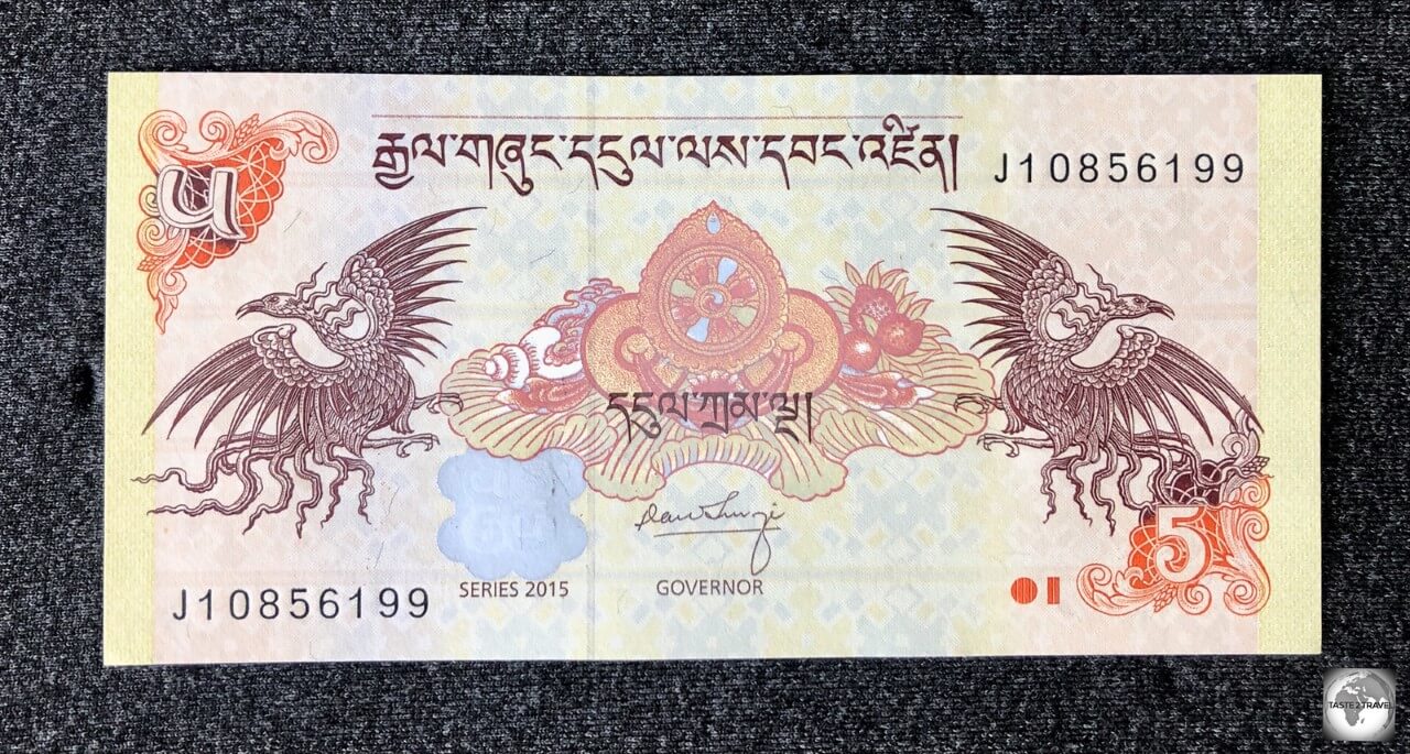 The 5-ngultrum banknote, which features two Bja Tshering, a mythical bird that brings about long life.