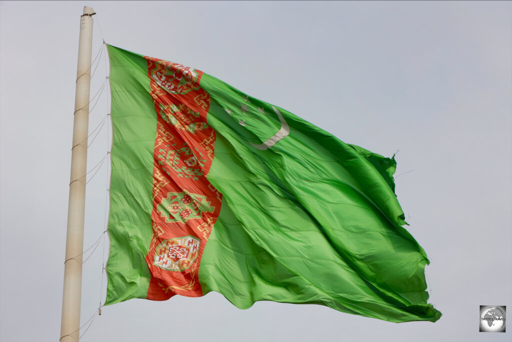 A giant Turkmenistan flag, flying over the city of Mary.