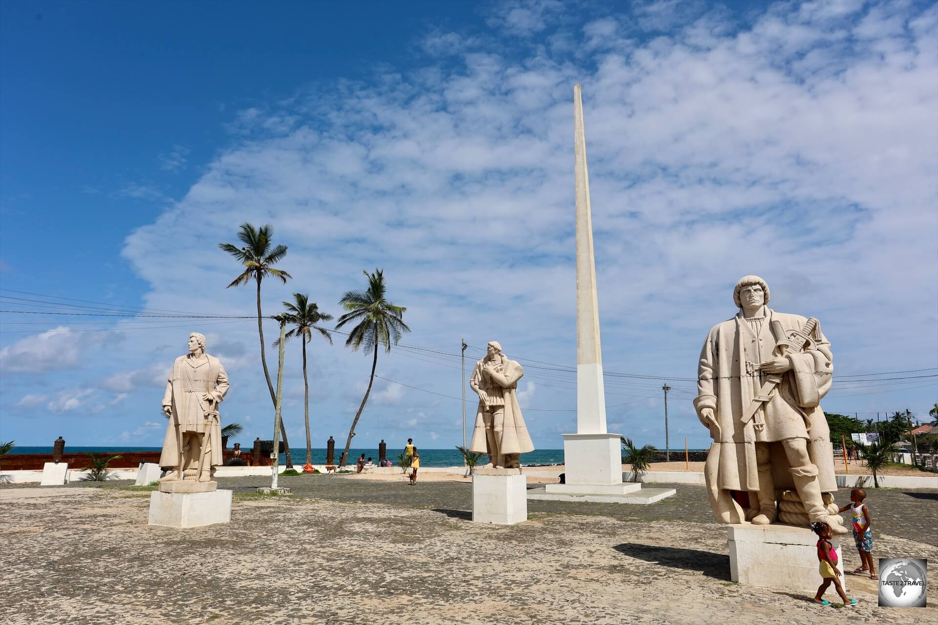 Statues of the three Portuguese explorers who discovered São Tomé stand in the small praça in front of San Sebastian fort.