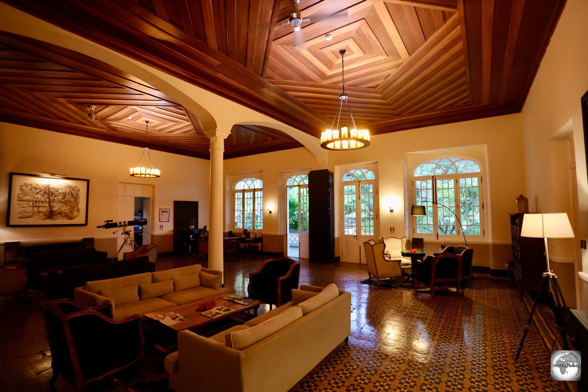 A view of the beautiful ceiling, which is made from local <i>marapião</i> wood, and the reception area at Hotel Roça Sundy. 