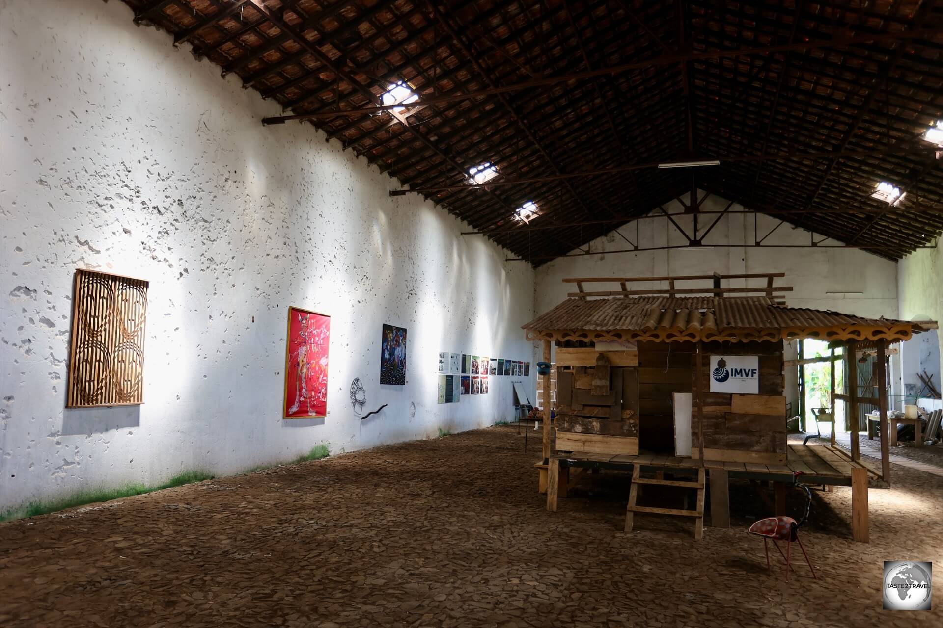 The walls of the former production facility at Roça Água Izé have been converted into gallery space where local artists display their works.