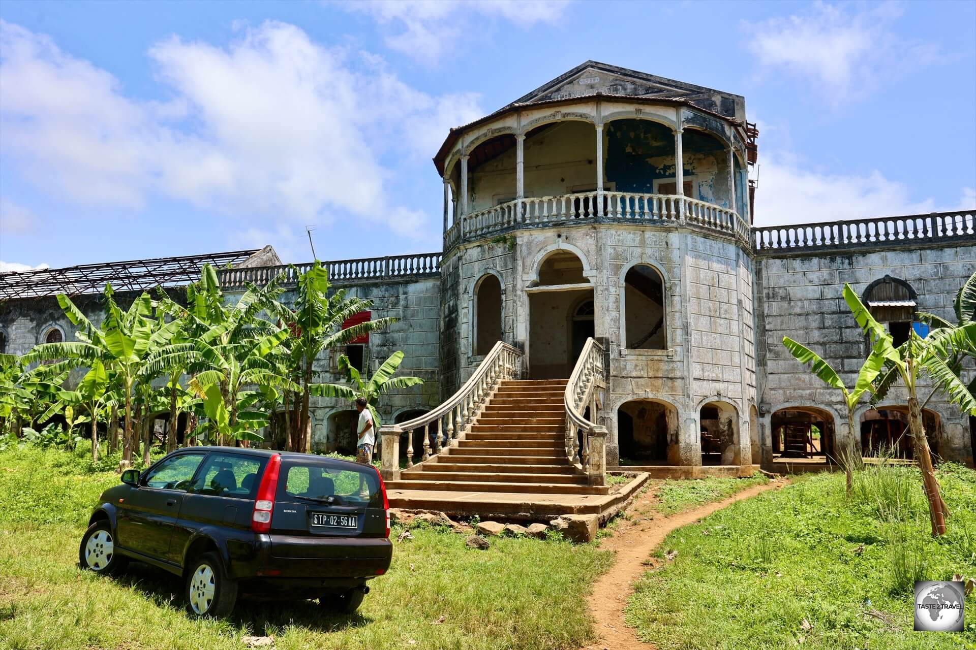 My rental car parked outside the abandoned <i>Roça de Água Izé Hospital</i>, once rated as the biggest and best hospital in central Africa.