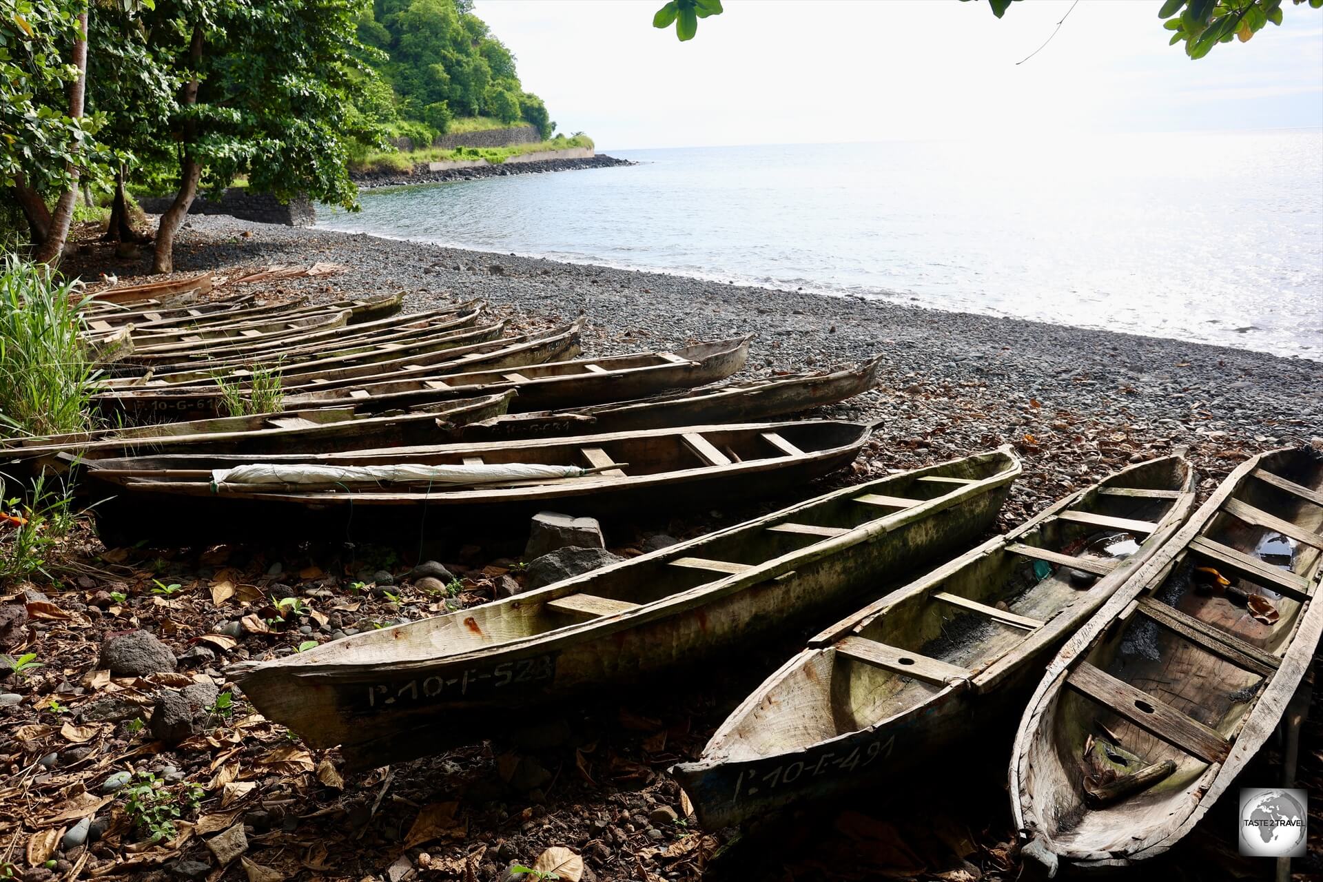 A view of a west coast beach, with many traditional wooden fishing boats, on São Tomé.