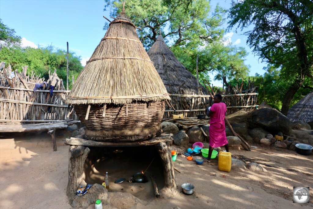 A village kitchen, with a fire below and food storage above.