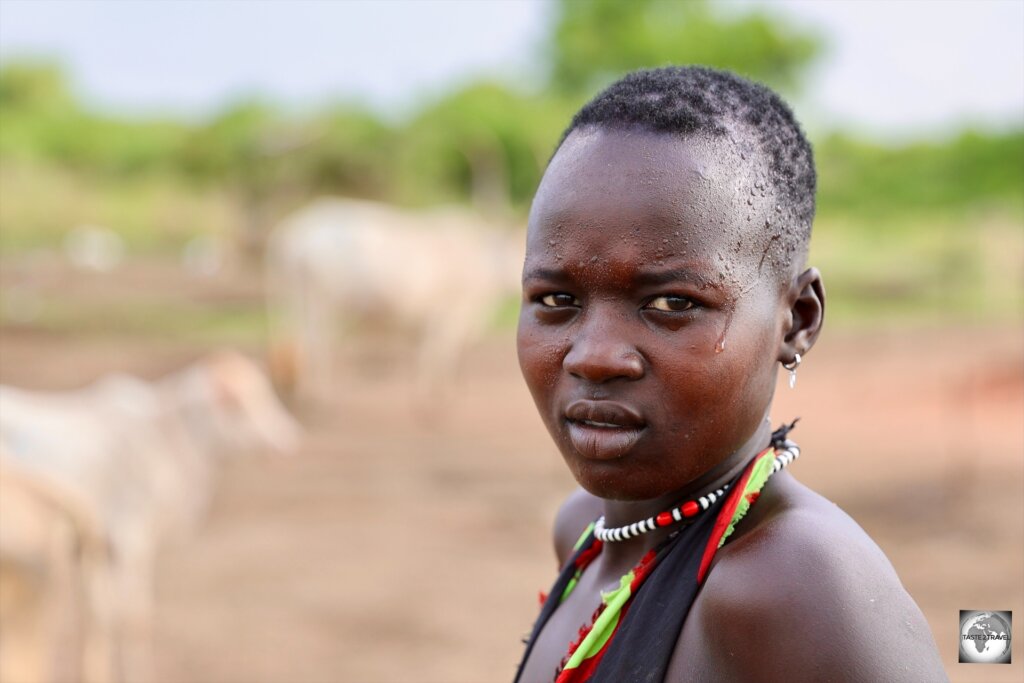 A young Mundari girl, working in the cattle camp.